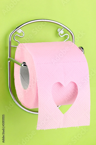 Photo: Roll of toilet paper on holder fixed to wall Roll of toilet paper on holder fixed to wall