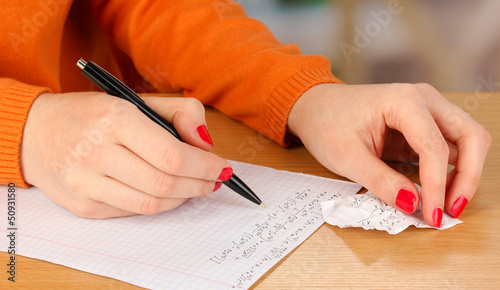 Photo: Write off exam on wooden table on room background Write off exam on wooden table on room background