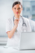 Young female dentist doctor holding chewing gum and smiling. Den