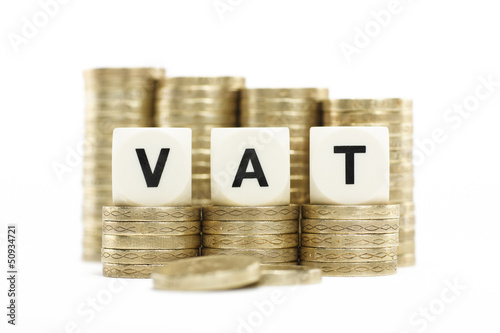 Photo: VAT (Value Added Tax) on gold coins on white background VAT (Value Added Tax) on gold coins on white background