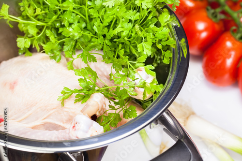 Photo: Chicken soup. Chicken and vegetables in pot close up Chicken soup. Chicken and vegetables in pot close up
