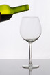 Ein Glas Rotwein eingiessen