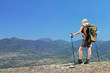 Foto: Woman with backpacki hiking a mountain Woman with backpacki hiking a mountain