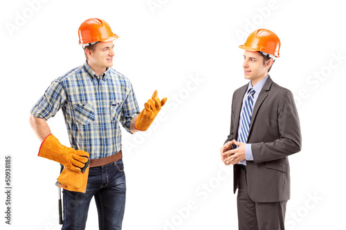 Photo: Male manual worker having a conversation with architect Male manual worker having a conversation with architect