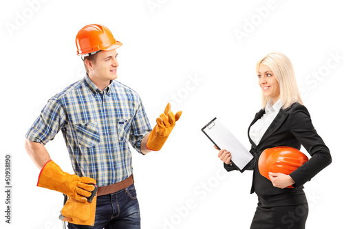Photo: Male manual worker having a conversation with female architect Male manual worker having a conversation with female architect