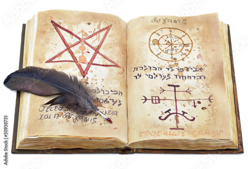 Photo: Magic book with feather isolated Magic book with feather isolated