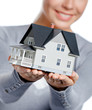 Close up of small model house in female hands, isolated on white