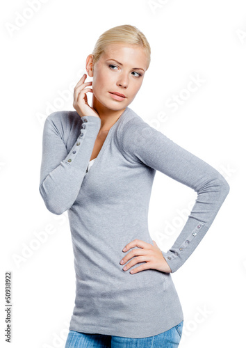 Photo: Woman in grey pullover admiring herself, isolated on white Woman in grey pullover admiring herself, isolated on white