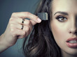 Sensual woman inserting card into her head