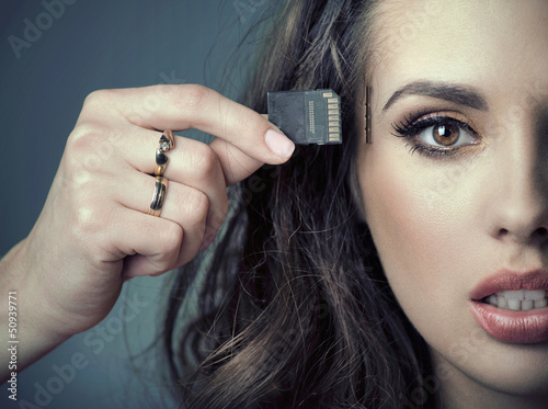 Photo: Sensual woman inserting card into her head Sensual woman inserting card into her head