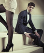 Young elegant man sitting on a stairs