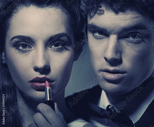 Photo: Young couple against the mirror Young couple against the mirror