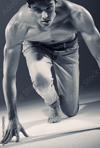 Photo: Muscular young man ready to start Muscular young man ready to start