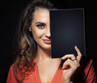 Beauty brunette hiding half of face behind black panel
