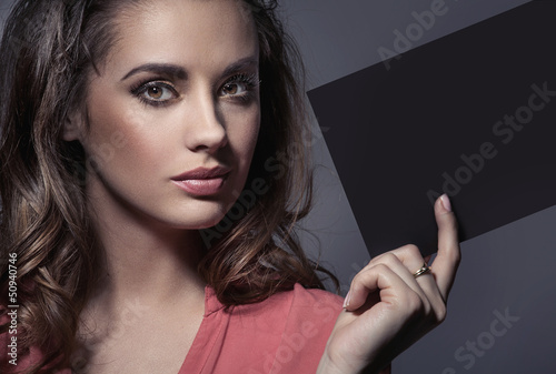 Photo: Elegant lady holding an empty sheet Elegant lady holding an empty sheet
