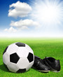 soccer ball and shoes in grass