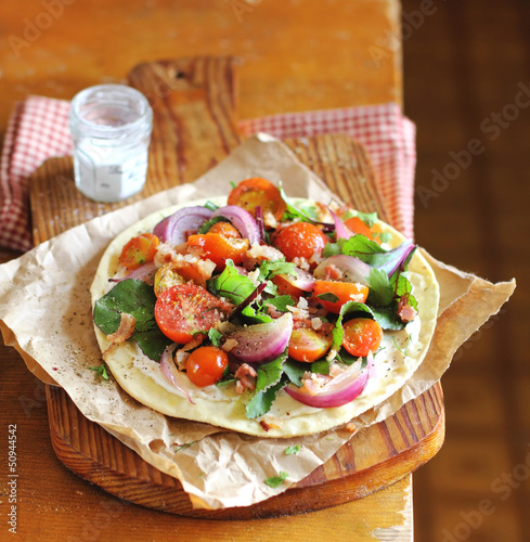 Photo: Wheat flat bread with chard leaves, cherry tomatoes Wheat flat bread with chard leaves, cherry tomatoes