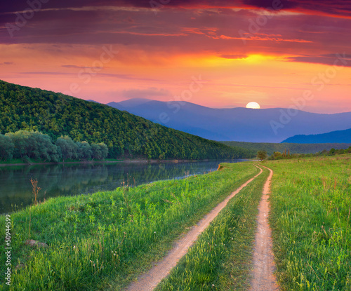 Photo: Beautiful summer landscape on the mountain river. Sunrise Beautiful summer landscape on the mountain river. Sunrise