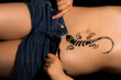 Sexy girl undressing with gecko tattoo