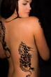 Beautiful female with tribal tattoos on her back