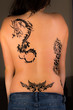 Beautiful female with tribal tattoos on her back