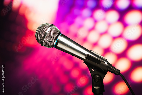 Photo: microphone against purple disco background microphone against purple disco background