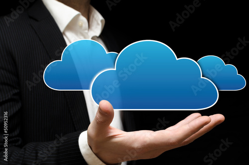 Photo: Businessman showing a cloud storage solution Businessman showing a cloud storage solution