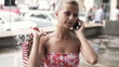 Woman talking on cellphone in the city, super slow motion