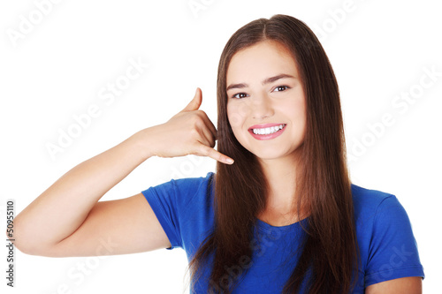 Photo: Lovely teen woman gesturing "call me" Lovely teen woman gesturing "call me"