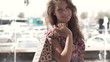 Happy woman with shopping bags in city, super slow motion