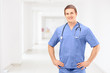 A male medical practitioner in a uniform posing in a clinic