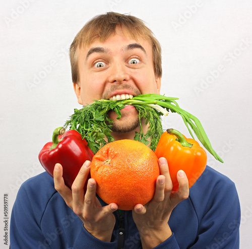 Photo: man gone mad on fresh vegetables and fruits man gone mad on fresh vegetables and fruits