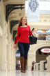 Happy young woman walking in the shop