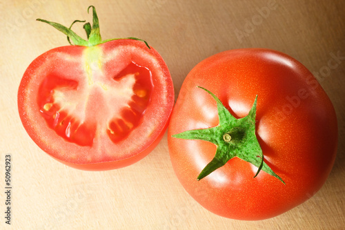 Photo: two fresh tomatoes on wooden cutting board two fresh tomatoes on wooden cutting board