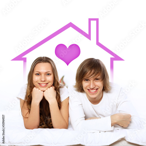 Photo: Young couple in white with heart symbols Young couple in white with heart symbols