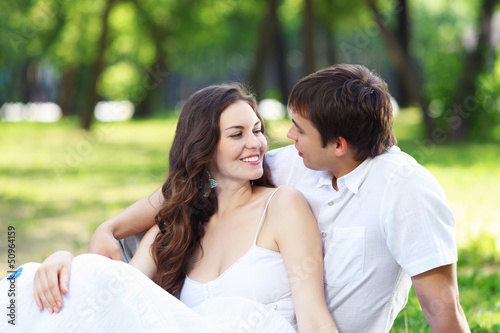 Photo: Young love Couple smiling under blue sky Young love Couple smiling under blue sky