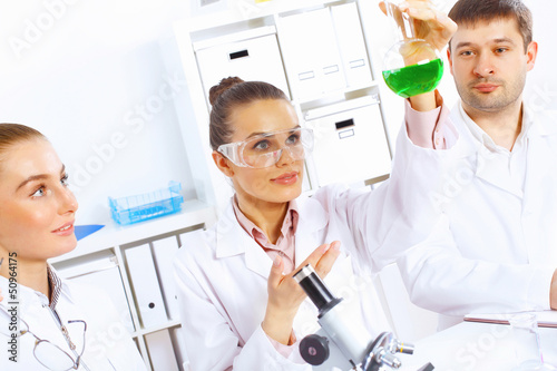 Photo: Team of scientists working in laboratory Team of scientists working in laboratory