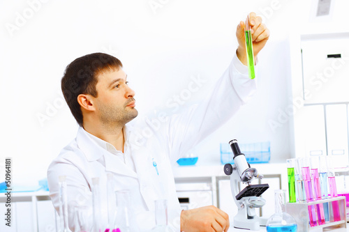 Photo: Young male scientist working in laboratory Young male scientist working in laboratory