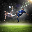 two football players striking the ball