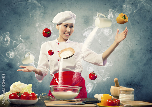 Photo: Asian female cooking with magic Asian female cooking with magic