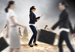 Businesswoman in blindfold among group of people