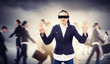 Businesswoman in blindfold among group of people