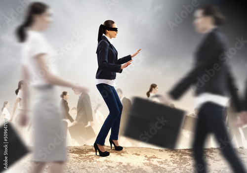 Photo: Businesswoman in blindfold among group of people Businesswoman in blindfold among group of people
