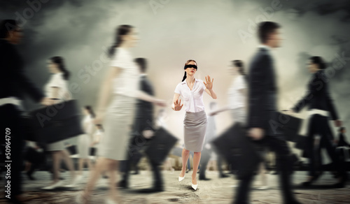 Photo: Businesswoman in blindfold among group of people Businesswoman in blindfold among group of people