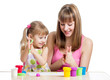 kid girl and mother playing colorful clay toy