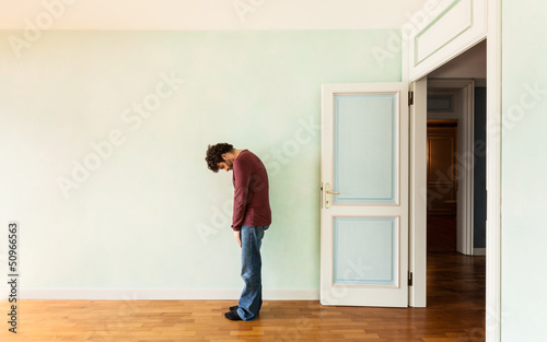 Photo: portrait of a weird guy in a room with the door open portrait of a weird guy in a room with the door open