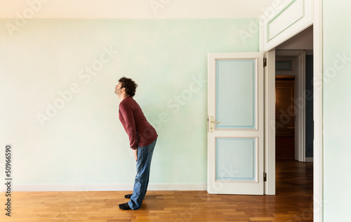 Photo: portrait of a weird guy in a room with the door open portrait of a weird guy in a room with the door open