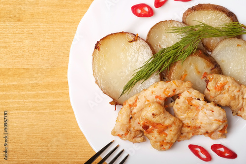 Photo: Potato slices with chicken - Top view Potato slices with chicken - Top view