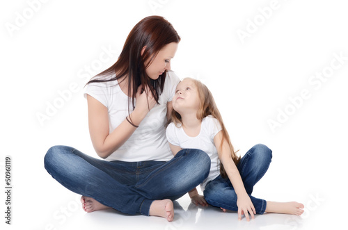 Photo: Mum with a daughter isolated on white Mum with a daughter isolated on white