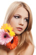 The beautiful woman with a Gerbera flower isolated on white